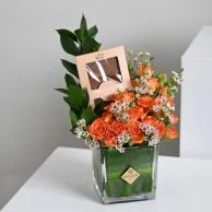 A vase of flowers and Levo chocolate