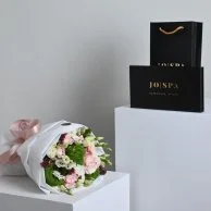 A bouquet of flowers with a gift card from Go Spa