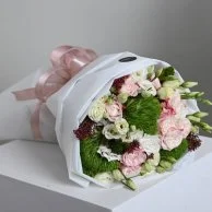 A bouquet of flowers with a gift card from Go Spa