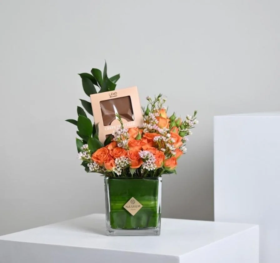 A vase of flowers and Levo chocolate