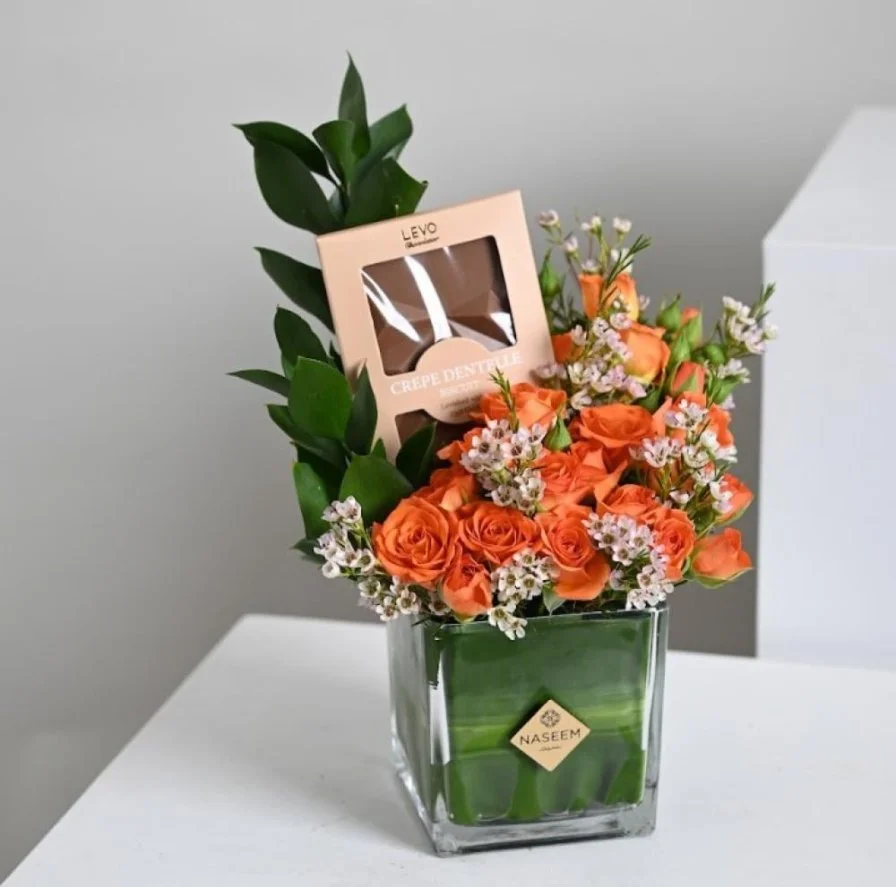 A vase of flowers and Levo chocolate