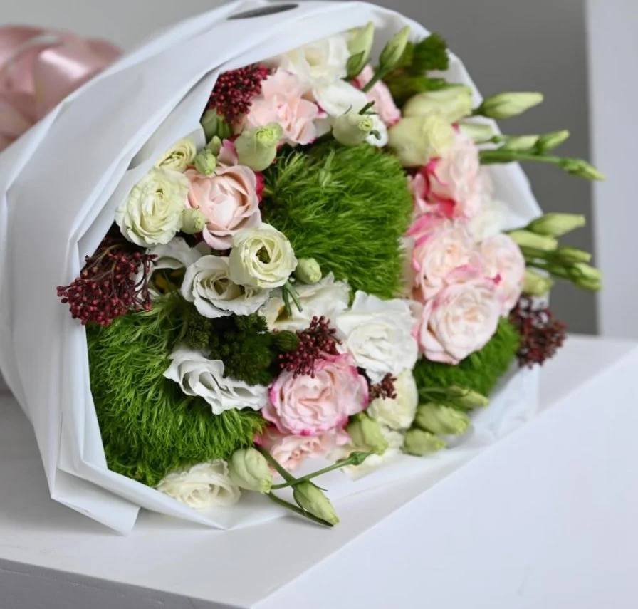 A bouquet of flowers with a gift card from Go Spa