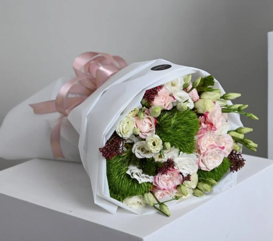 A bouquet of flowers with a gift card from Go Spa