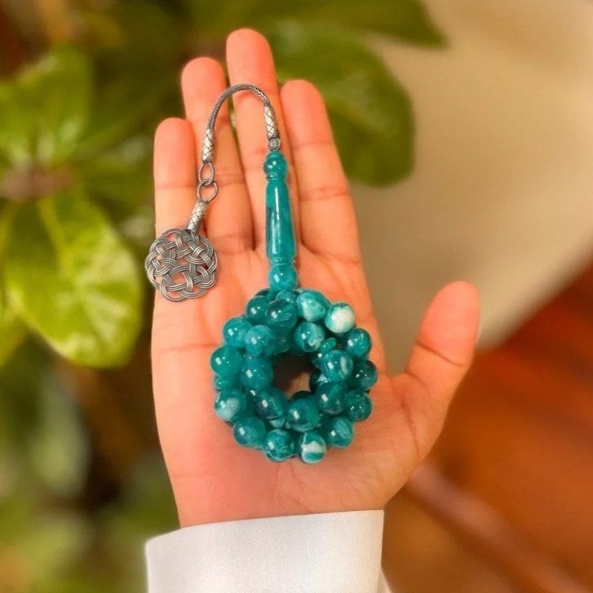 Green anthurium vase with a rosary from Shakah